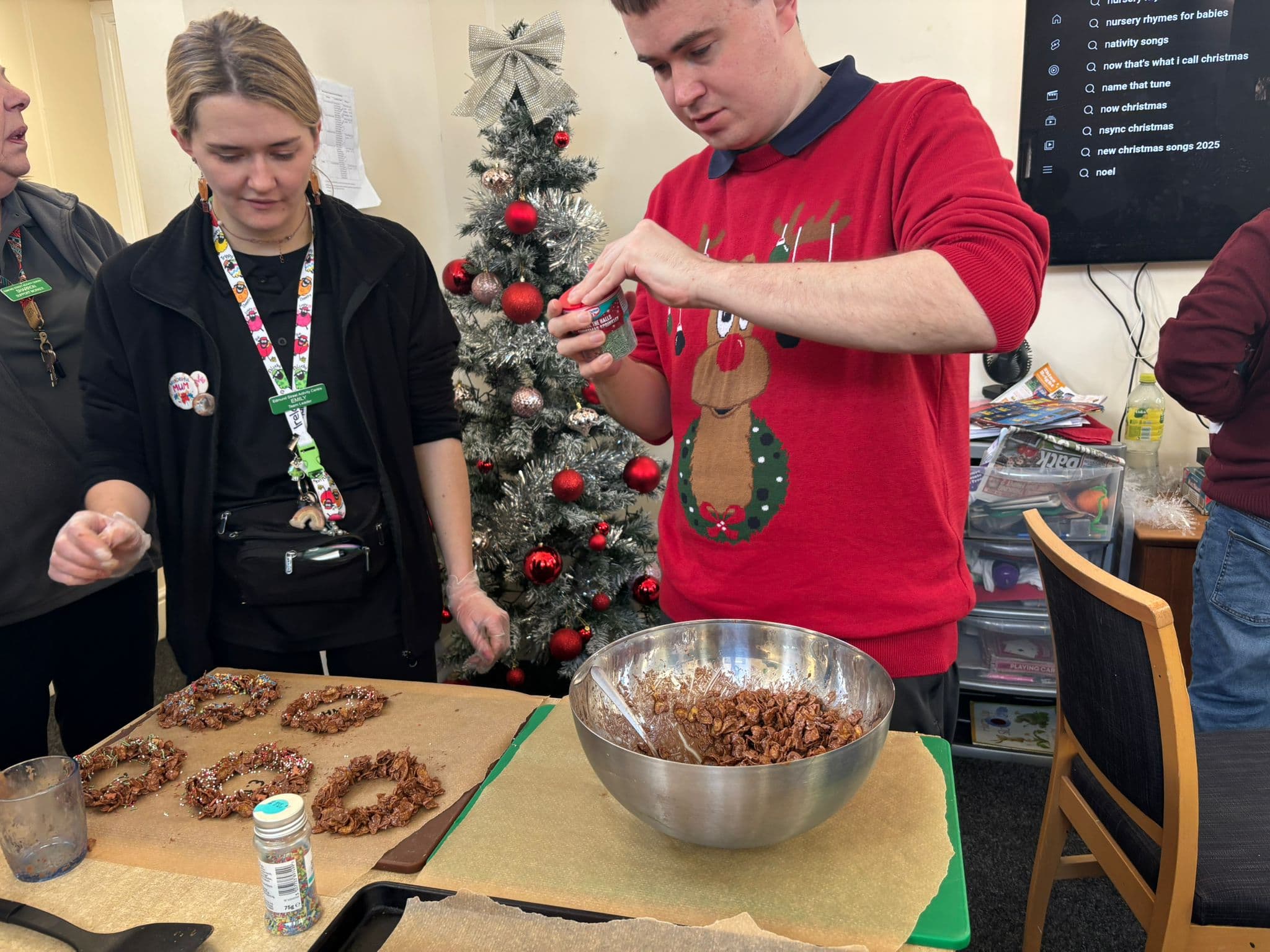 A carer supporting a young adult one-to-one with an activity